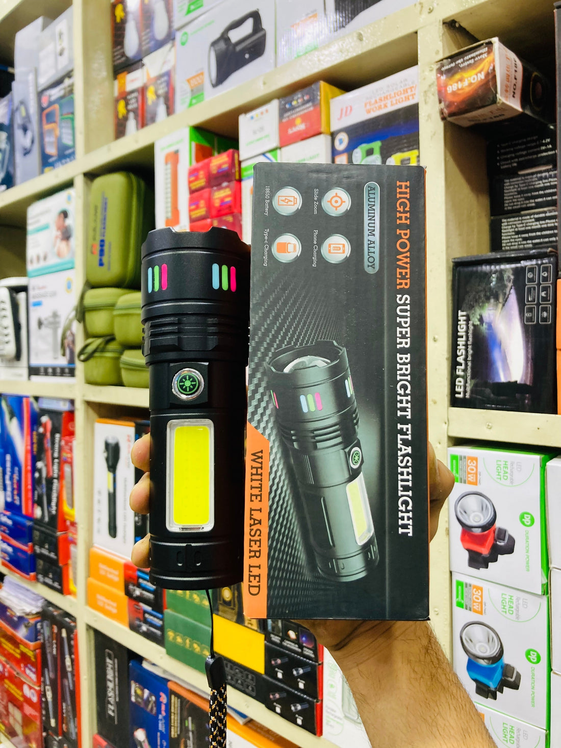 High range aluminium torch under 3500 with powerful 100m beam and long battery backup for load shedding and emergency use in Pakistan